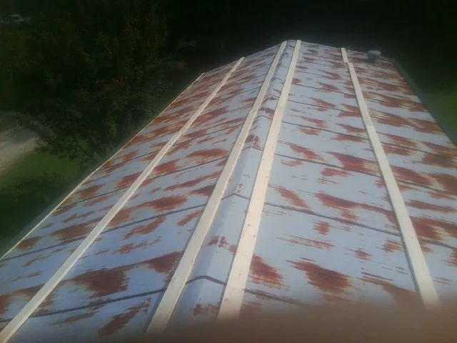 Rusted metal roof panels with new wood purlins before replacement — Storm Damage Roof Repair in Centerburg by Roofing Brothers