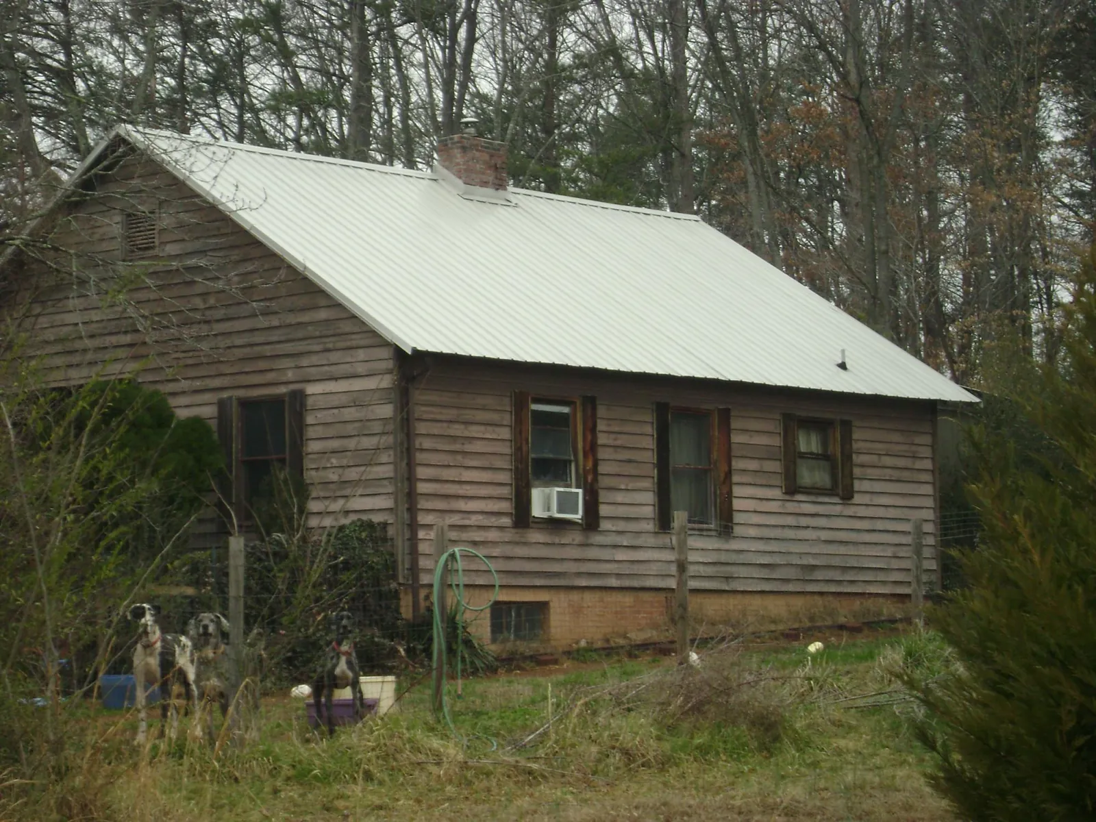 White metal roof on an old wood sided farmhouse, from a Metal Roof Installation job in Centerburg